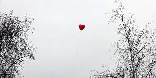 Ein herzförmiger Luftballon steigt gen Himmel Ein herzförmiger Luftballon steigt gen Himmel